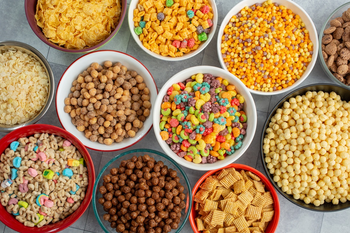 Assorted manufactured foodstuffs including cereals and snacks in many bowls. 