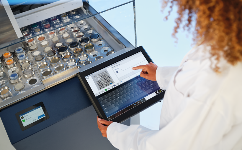 Making XRF Easy - woman operates the S8 TIGER XRF spectrometer on a touchscreen