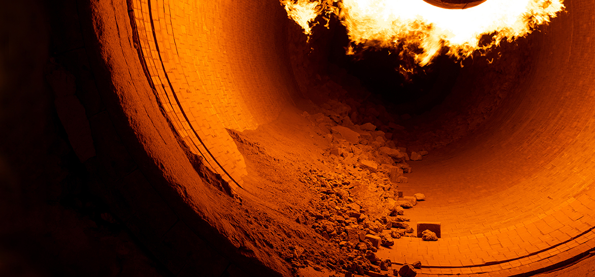 Close up of flame in rotary kiln during heating mode in cement plant