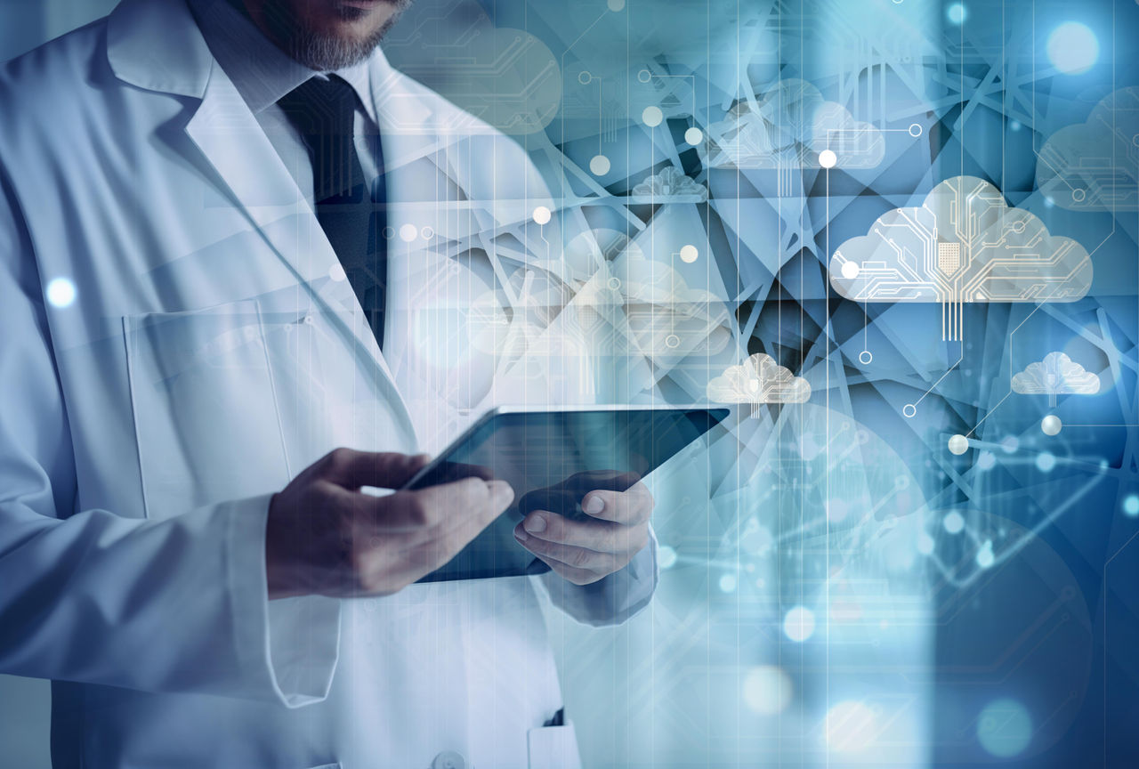 Medical professional in a white coat using a digital tablet for patient data in a bright, high-tech hospital environment