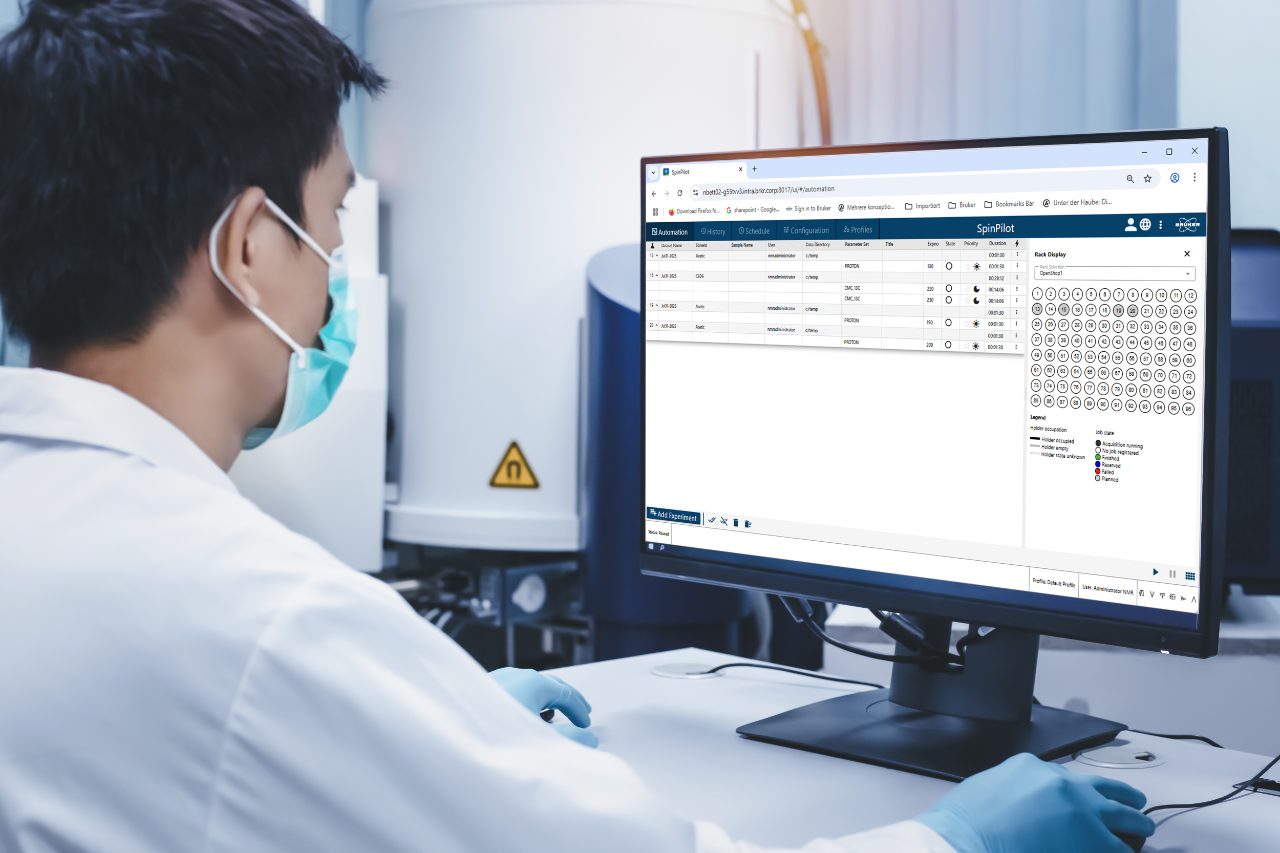 Scientist man checks the spectrum of sample analysis by nuclear magnetic resonance spectroscopy, NMR spectroscopy, as shown on a computer monitor in the laboratory.