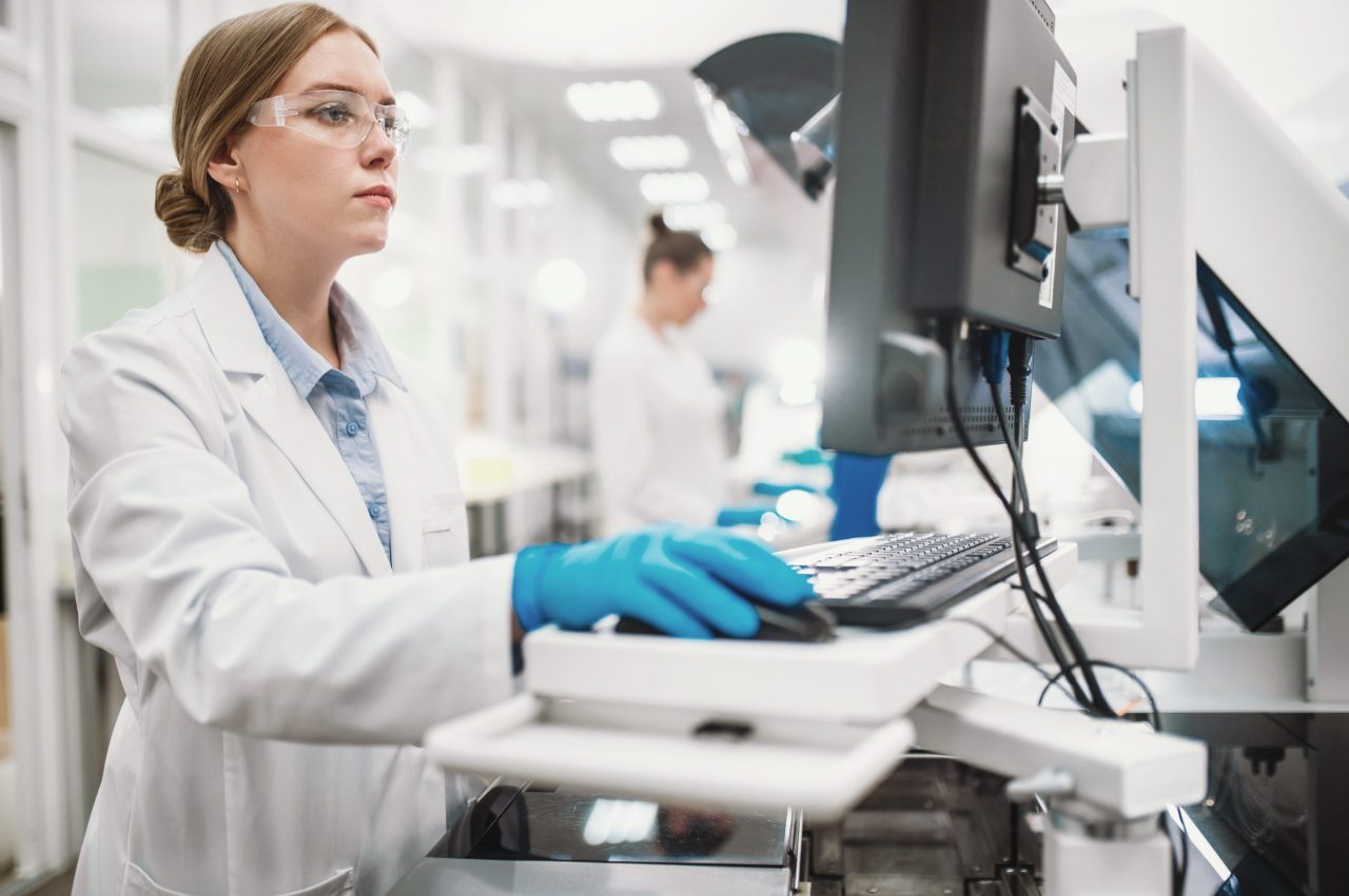 Two female scientists work in a modern equipped computer laboratory