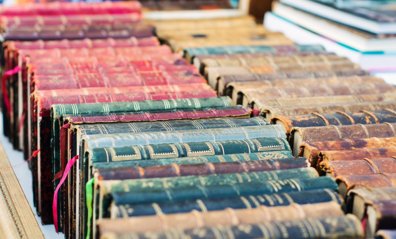 Books lined up for screening. Some of the books have the colour of Paris Green - a suspect pigment that contains Arsenic.