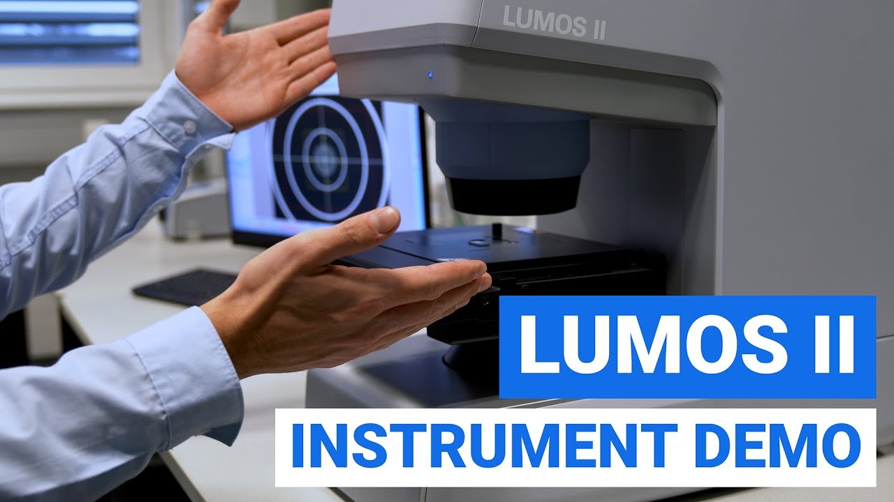 Image showing LUMOS FT-IR microscope and hands pointing at it. Big captions explain to click this image to request and on-demand demo video