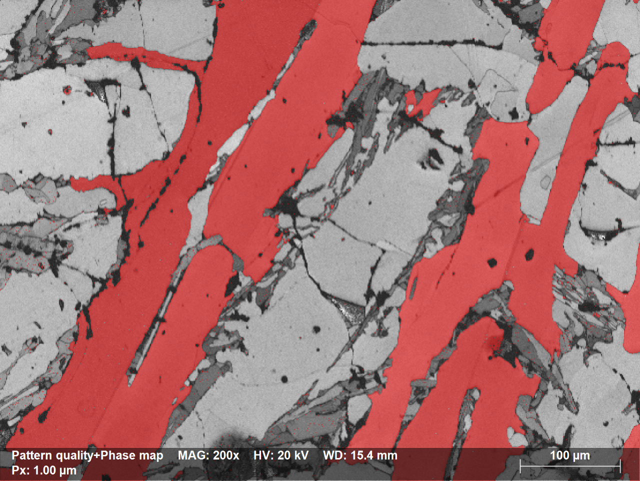 Fig. 1.2: Pattern Quality Map overlapped with phase map showing Si grains in red; to minimize the time required to setup the EBSD measurement on samples with unknown type and number of phases, one can launch the acquisition without identifying all phases; all other phases can be identified offline, at a latter time and complete the map using the extreme re-indexing power of ESPRIT software