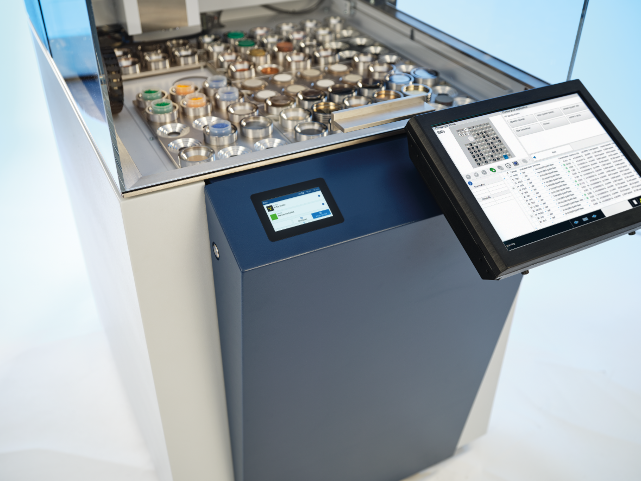 Image showing many different types of samples loaded into the S8 TIGER for elemental analysis. The AI-powered grabber hovers overhead.