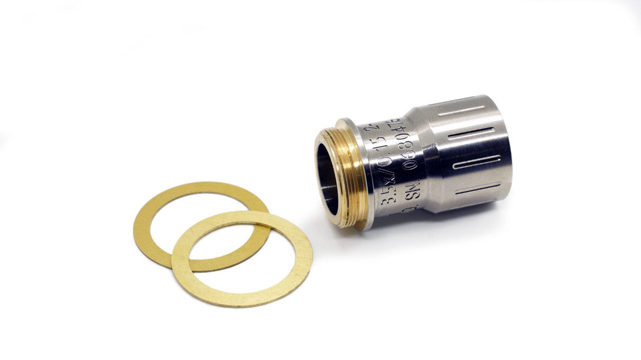 Silver infrared microscopy objective lens on grey table. 