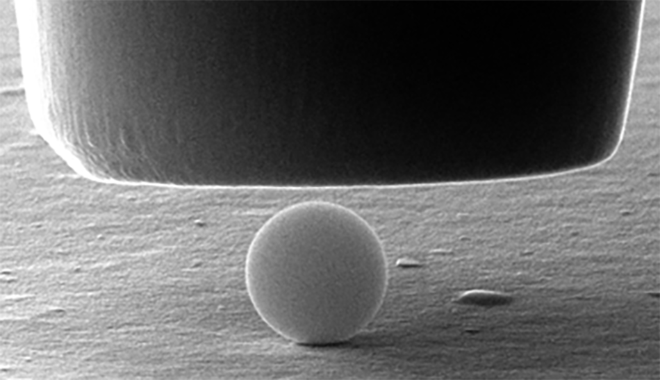 Image of a 1 µm silica particle before being compressed by a 5 µm flat punch probe, as part of the investigation into the mechanical properties of silica glass.