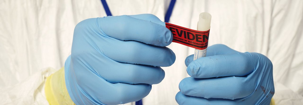 A test tube is labeled with a sticker that says "evidence".