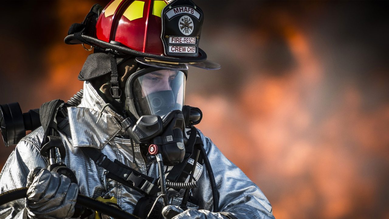 Firefighter in protective clothing and oxygen mask.