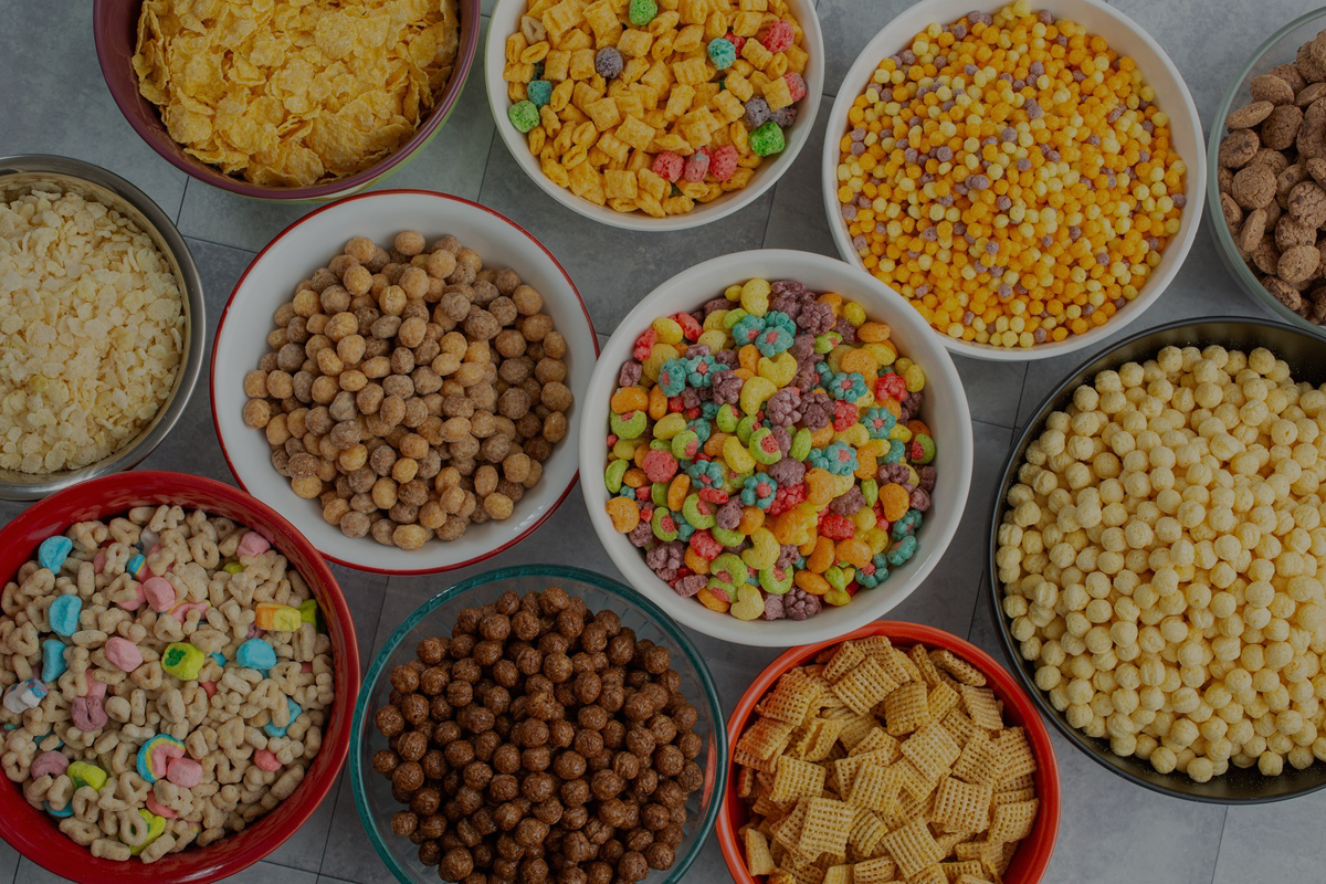 Many different manufactured cereal and grain products in bowls