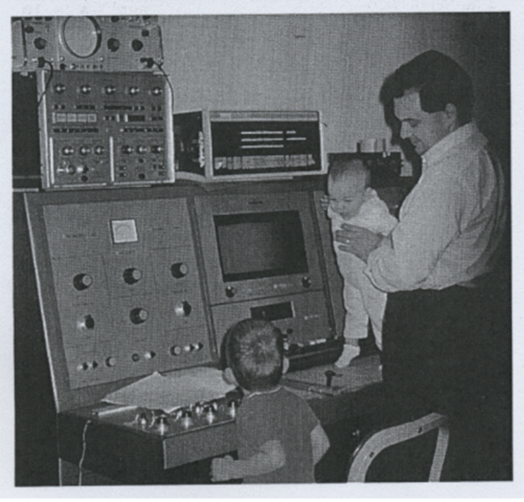 Tony Keller with his two children at one of the first NMR spectrometers