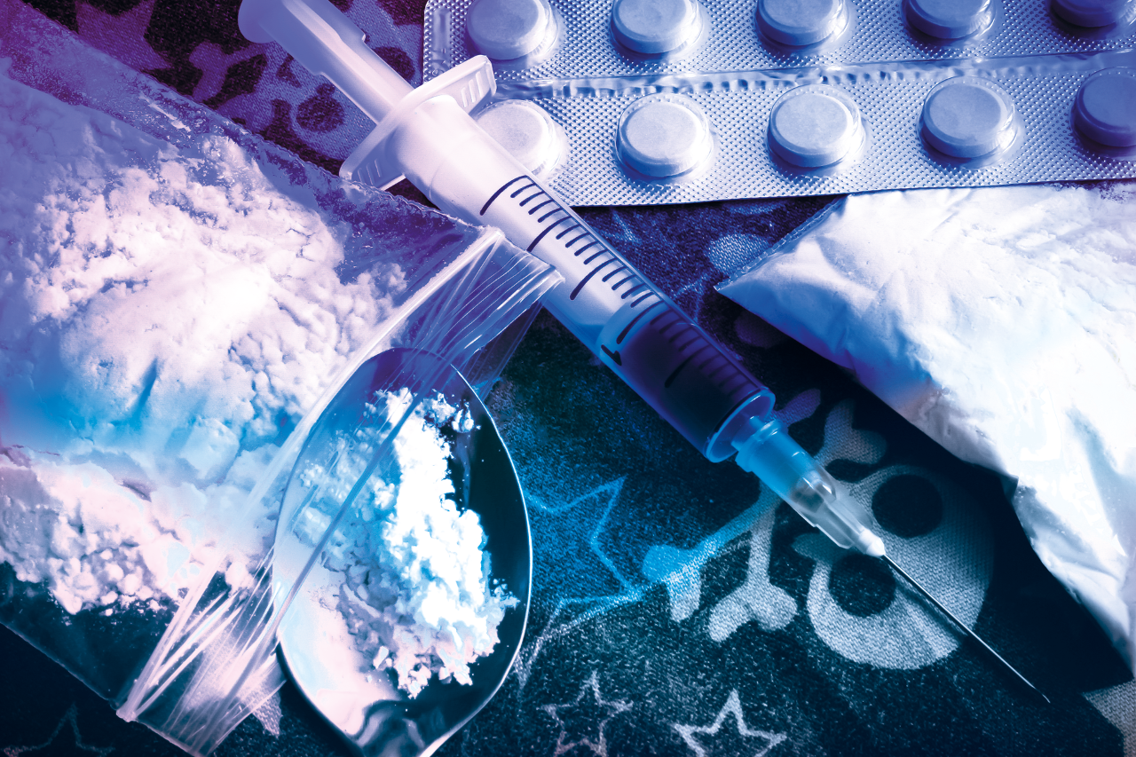 All sorts of drugs, such as heroin in transparent bags, a syringe and spoon, and tablets.