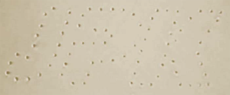 Eighty tiny silica beads trapped by lasers, arranged to look like the JPK logo.
