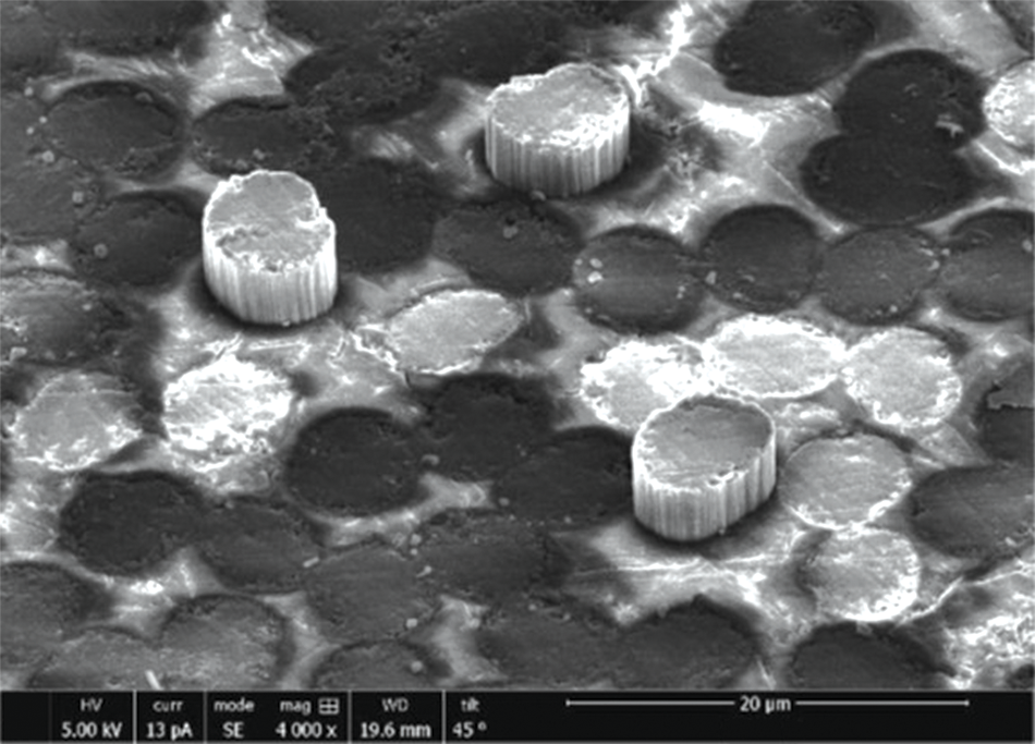 Image of the backside of a sample material after conducting a fiber push-out test. The image shows complete push-out of the tested fibers from the matrix material. 