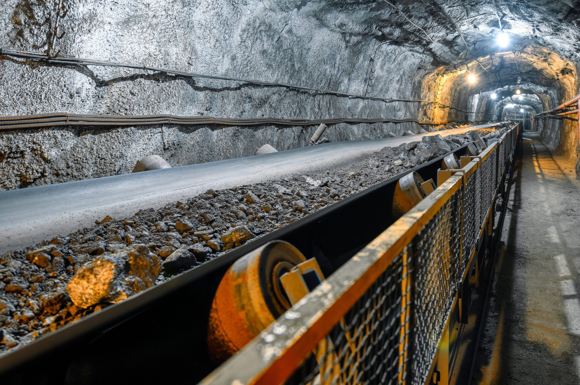 metal ore rocks on mine conveyer belt