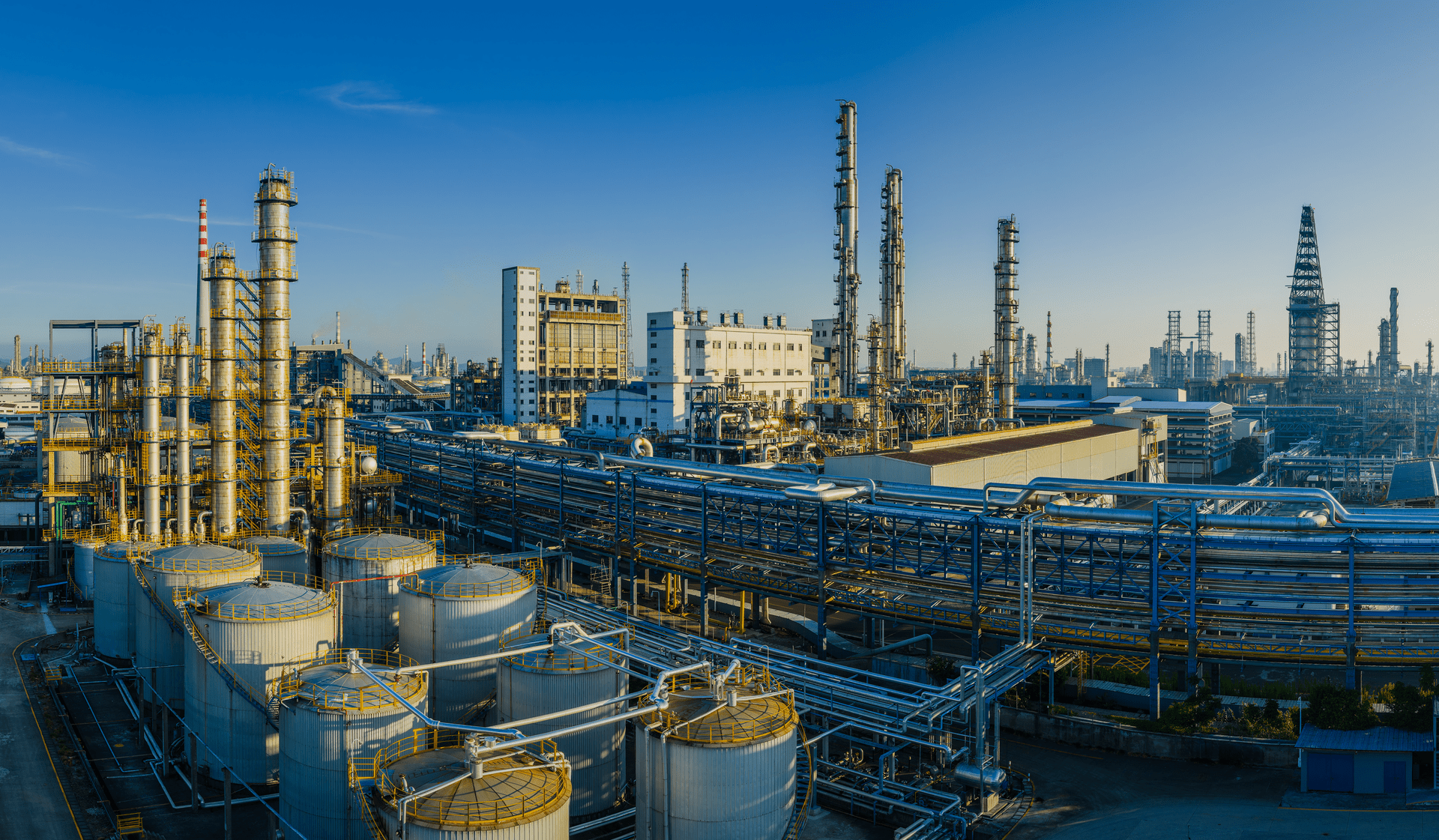 A large oil refinery and petrochemical plant with complex equipment in industrial area 